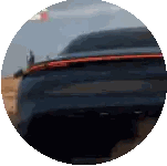 a blue car is driving through a desert in a circle