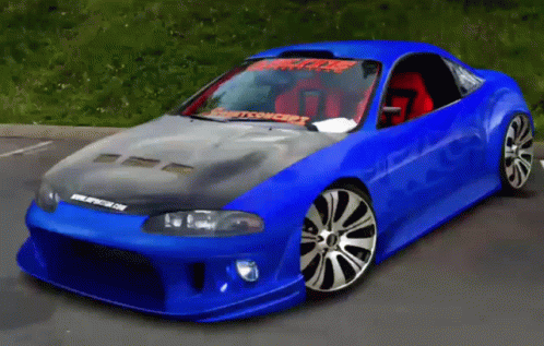 A Blue Car Is Parked In A Parking Lot And Has A Sticker On The Windshield That Says Spitfire On It GIF