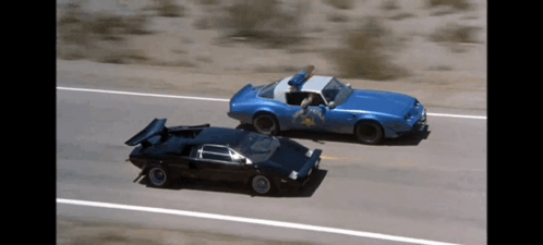 A Blue Car With A Sheriff 'S Badge On It GIF