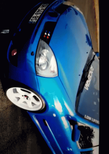 A Blue Car With A Sticker That Says Low Lifes GIF