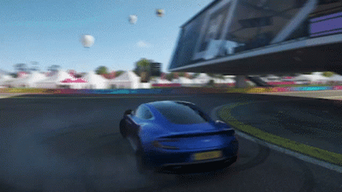 A Blue Car With A Yellow License Plate Is Driving Down A Track GIF