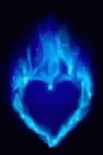 A Blue Heart Is Surrounded By Blue Flames On A Dark Background . GIF