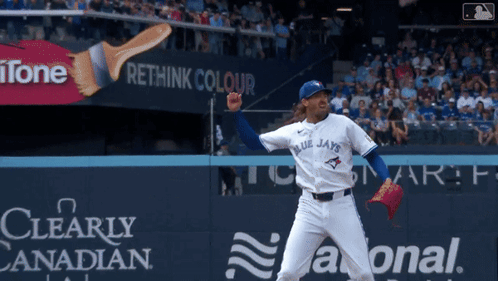A Blue Jays Pitcher Throws A Pitch In Front Of An Ad For Rethink Colour GIF