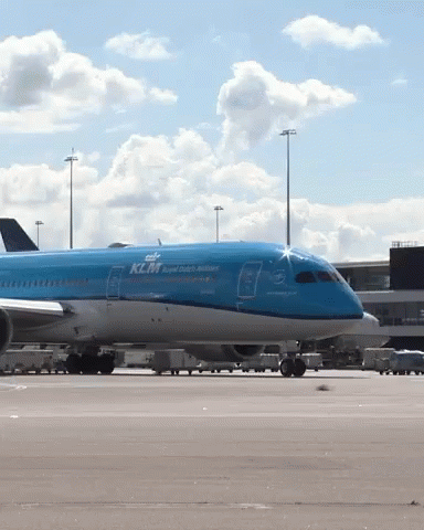A Blue Klm Airplane Sits On The Tarmac At An Airport GIF
