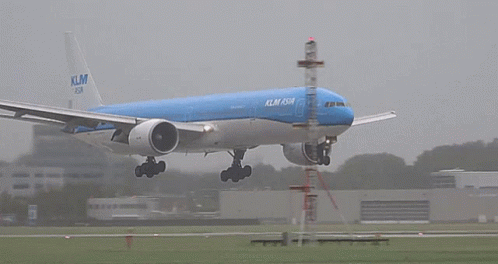 a blue klm asia airplane is taking off