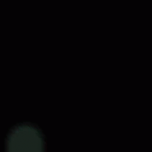 a blue light is shining through a dark background