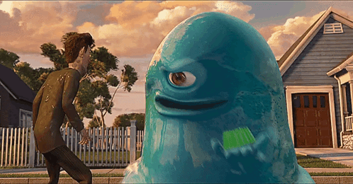 A Blue Monster With A Single Eye Is Standing In Front Of A House GIF