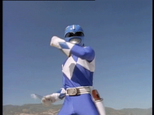 a blue power ranger is standing in front of a blue sky holding a sword .