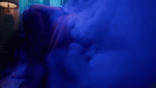 A Blue Smoke Filled Room With The Words " I Feel The Lavender Haze " On The Bottom GIF