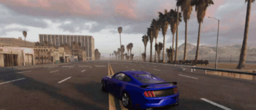 A Blue Sports Car Is Driving Down A Road With Palm Trees In The Background GIF