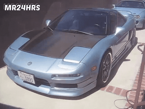 A Blue Sports Car With California License Plate 1891 Is Parked In A Driveway GIF