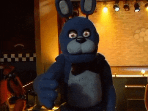 Blue Stuffed Animal Pointing At Camera GIF