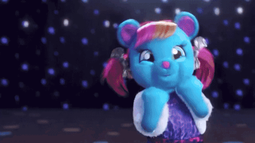a blue teddy bear with pink hair and a purple dress