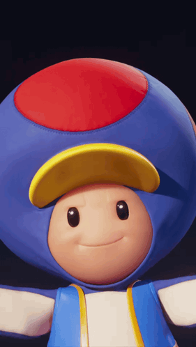 A Blue Toad With A Red Yellow And Blue Hat GIF