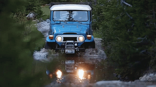 A Blue Toyota Jeep Driving Through A River GIF