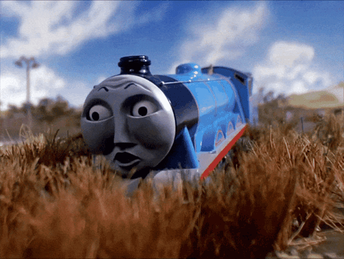 A Blue Train With The Name Gordon On The Side Of It GIF