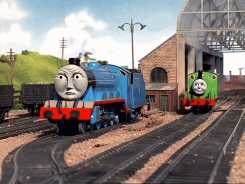 A Blue Train With The Number 1 On It Is On The Tracks GIF