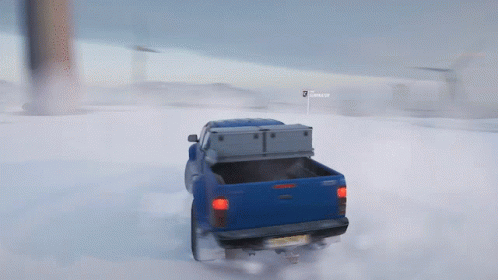 A Blue Truck Is Driving Through The Snow With A Sign That Says Snooper GIF