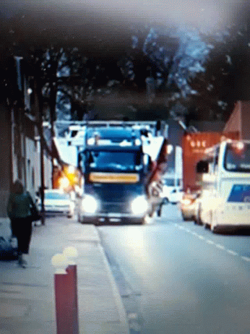 A Blue Truck Is Parked On The Side Of A Street GIF