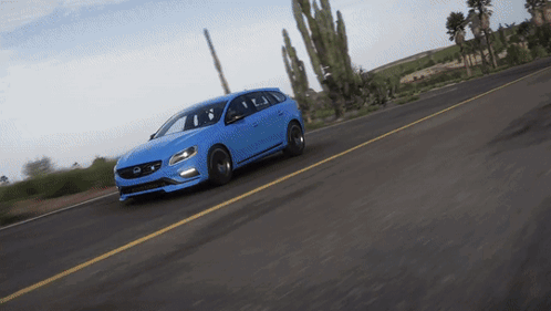 A Blue Volvo Is Driving Down The Road GIF