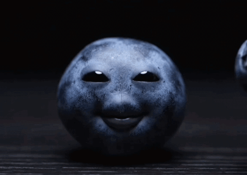 A Blueberry With A Face On It GIF