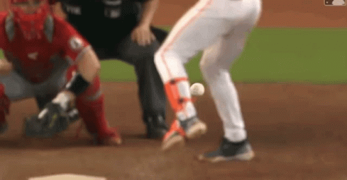 A Blurred Image Of A Baseball Game With A Catcher And Umpire GIF