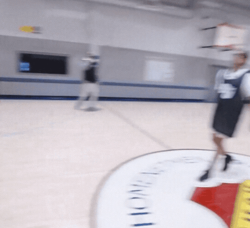A Blurred Image Of A Basketball Court With A Sign That Says Lone Star GIF
