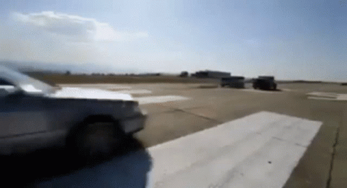 A Blurred Image Of A Car Driving Down A Runway GIF
