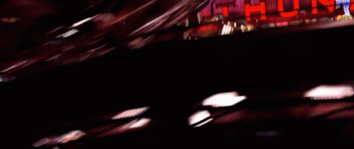 A Blurred Image Of A Car Driving Past A Sign That Says ' Urd ' GIF