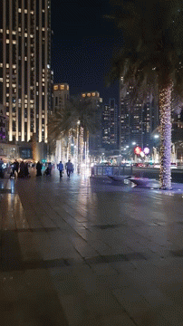 A Blurred Image Of A City Street At Night With A Sign That Says ' A ' On It GIF