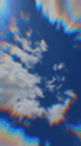 A Blurred Image Of A Cloudy Sky With A Rainbow In The Middle . GIF