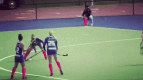 A Blurred Image Of A Field Hockey Game With A Player Wearing A Number 2 Jersey GIF
