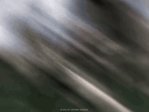 A Blurred Image Of A Gray Cloth With A Copyright Watermark GIF