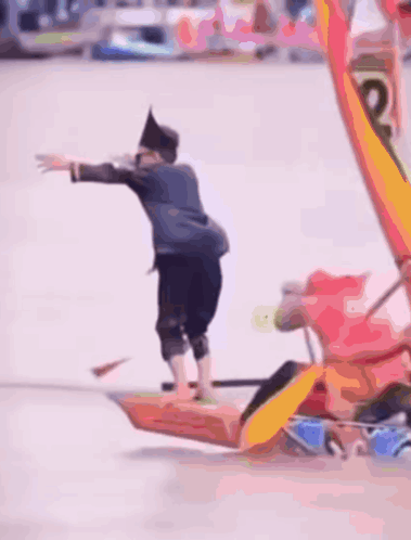 A Blurred Image Of A Group Of People In A Boat That Says ' Coca Cola ' On The Side Of It GIF