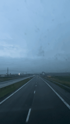 A Blurred Image Of A Highway With A Blue Sky GIF