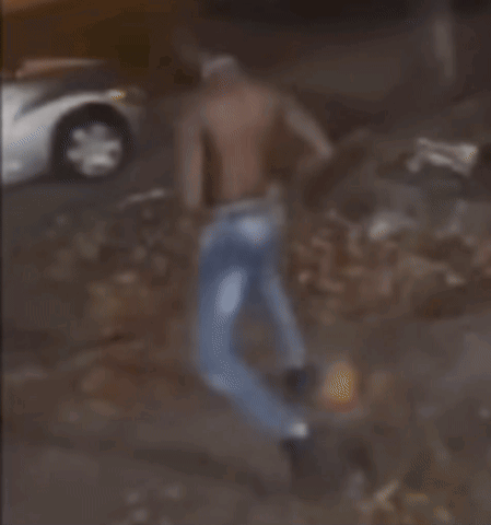 a blurred image of a man standing in front of a car