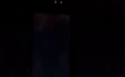 A Blurred Image Of A Person In A Dark Room GIF