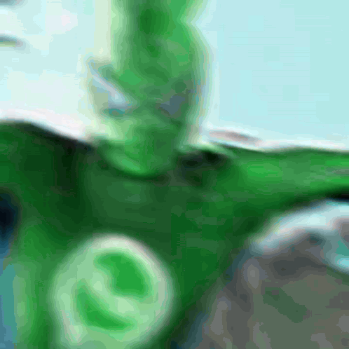 A Blurred Image Of A Person In A Green Costume GIF