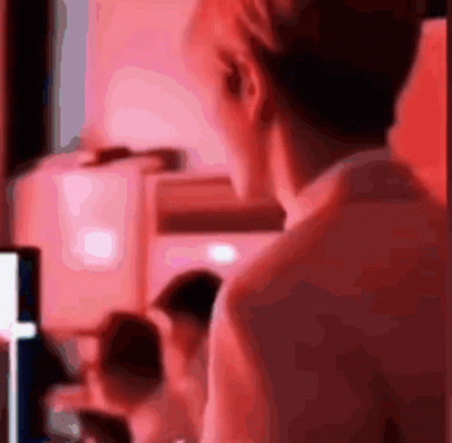 A Blurred Image Of A Person 'S Back With A Red Background GIF
