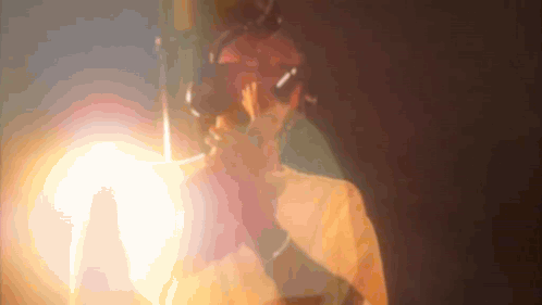 A Blurred Image Of A Person 'S Face With A Light Behind Them GIF