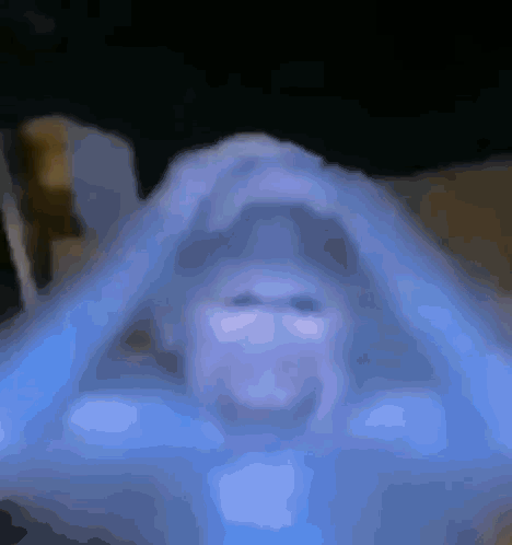 A Blurred Image Of A Person 'S Face With A Triangle In The Middle GIF