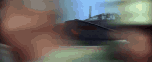 a blurred image of a person 's face with the letters t and j visible