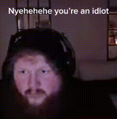A Blurred Image Of A Person 'S Face With The Words Nyehehe You 'Re An Idiot Written Above It . GIF
