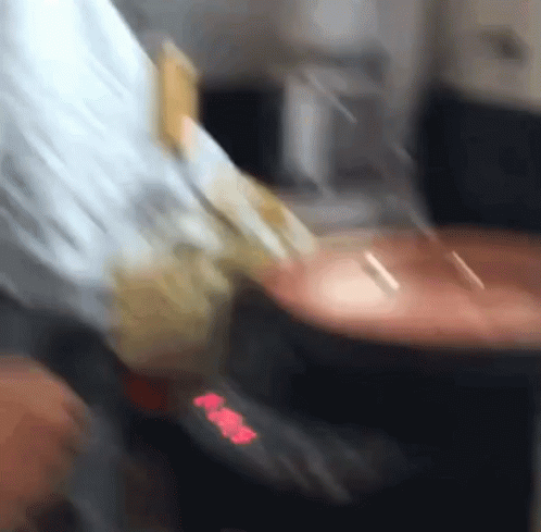 A Blurred Image Of A Person 'S Hand Holding A Piece Of Paper That Says ' Aa ' GIF