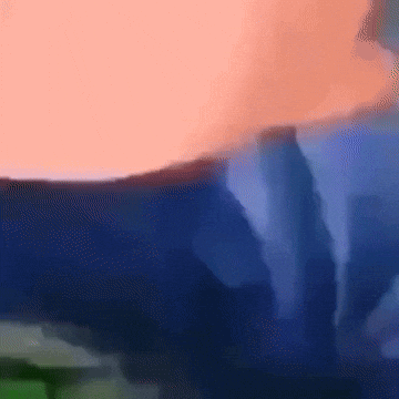 A Blurred Image Of A Person 'S Torso With A Blue Background GIF