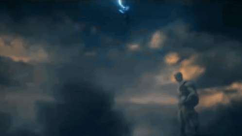 A Blurred Image Of A Person Standing In Front Of A Blue Background GIF
