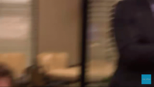A Blurred Image Of A Person Standing In Front Of A Sign That Says " Be The One " GIF