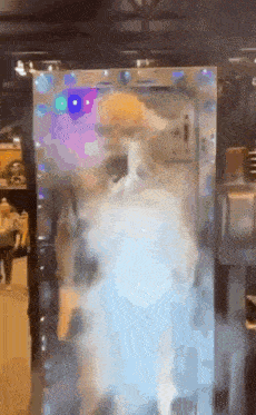 A Blurred Image Of A Person Standing In Front Of A Wall GIF