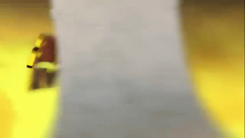 A Blurred Image Of A Person Standing Next To A White Object . GIF