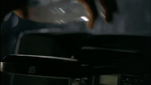 A Blurred Image Of A Person Standing On A Desk GIF